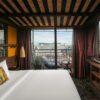 Luxury hotel room in Hanoi with balcony view of the city.