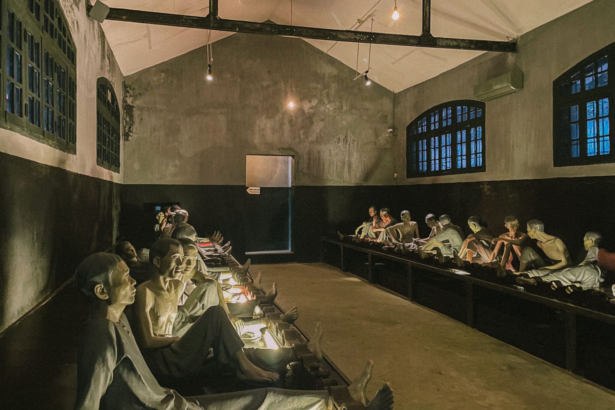 Hanoi's Hoa Lo Prison exhibit: Mannequins depict prisoners in dim cells, a grim reminder of Vietnam's history.
