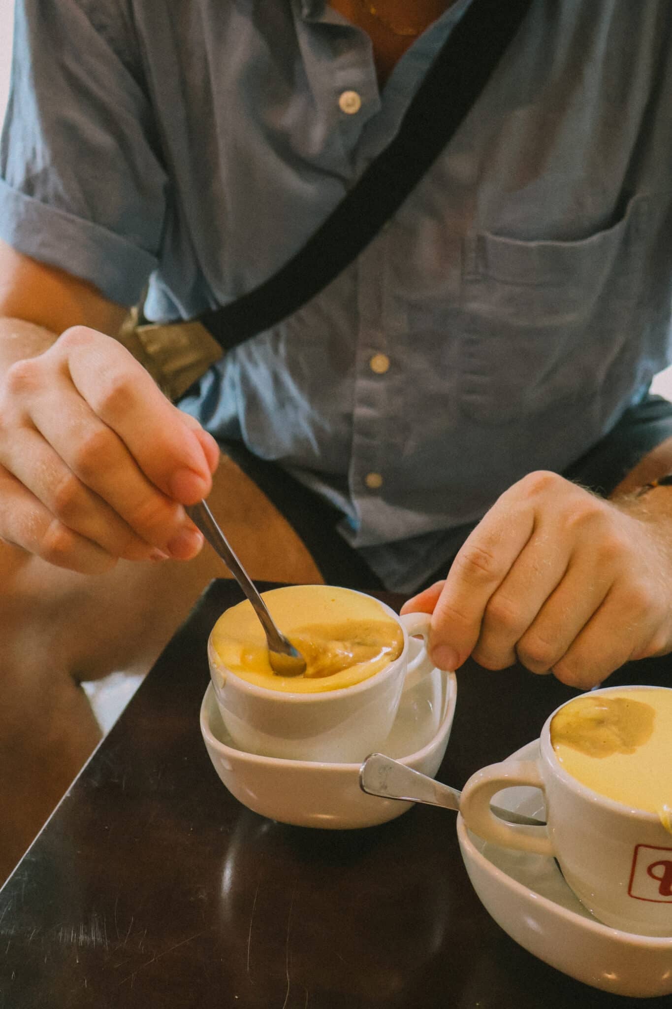Man enjoying egg coffee, a Hanoi hidden gem, in Vietnam.