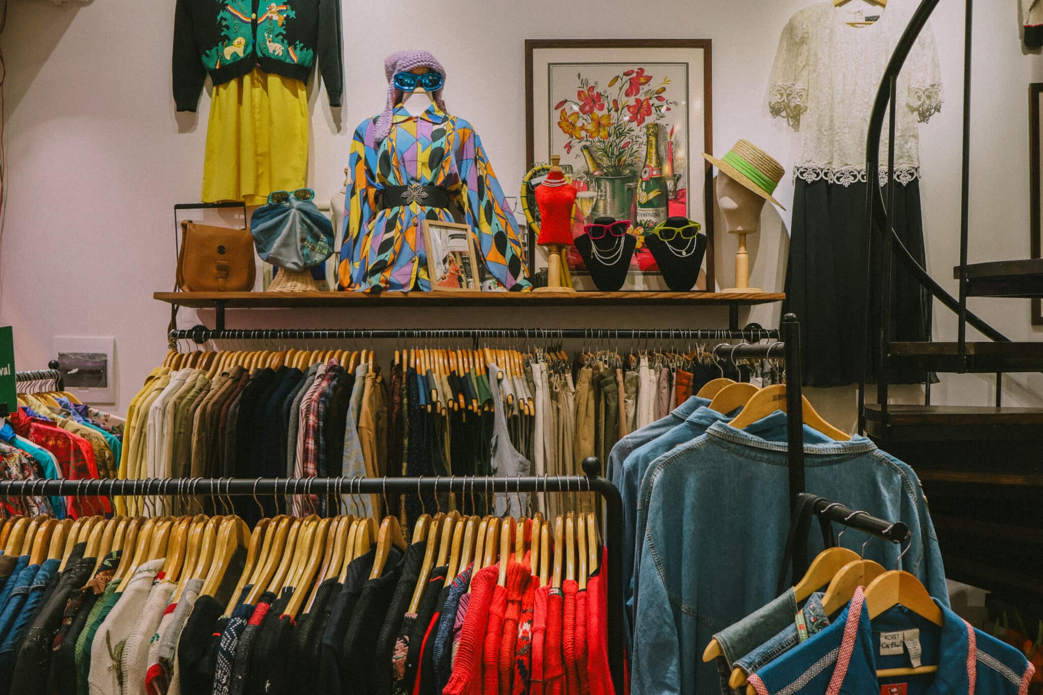 Vintage clothing store in Hanoi, Vietnam, with racks of clothes and mannequins.