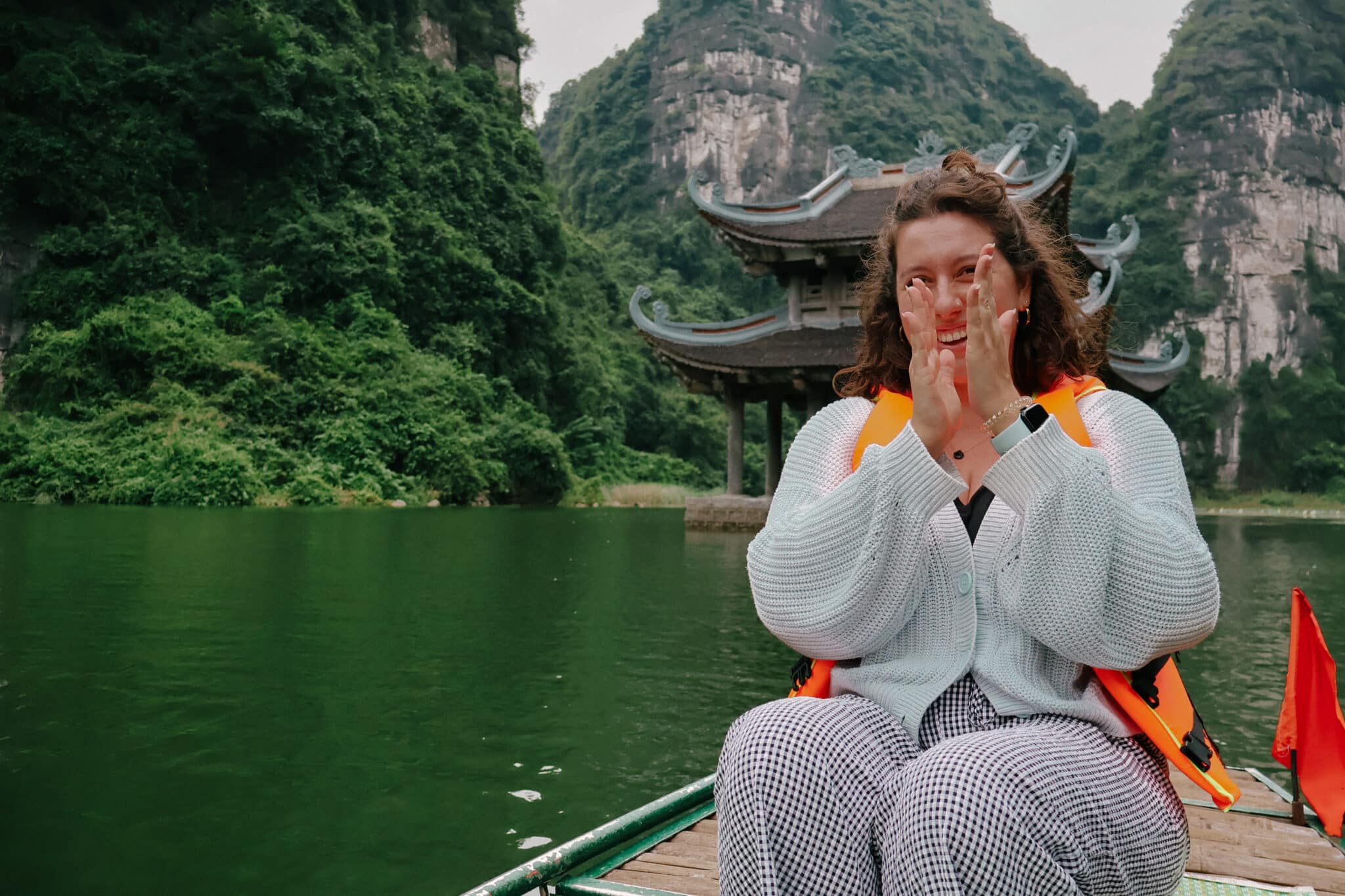 Rachel in Ninh Binh, Vietnam, a Northern Vietnam hidden gem, with pagoda and mountains.