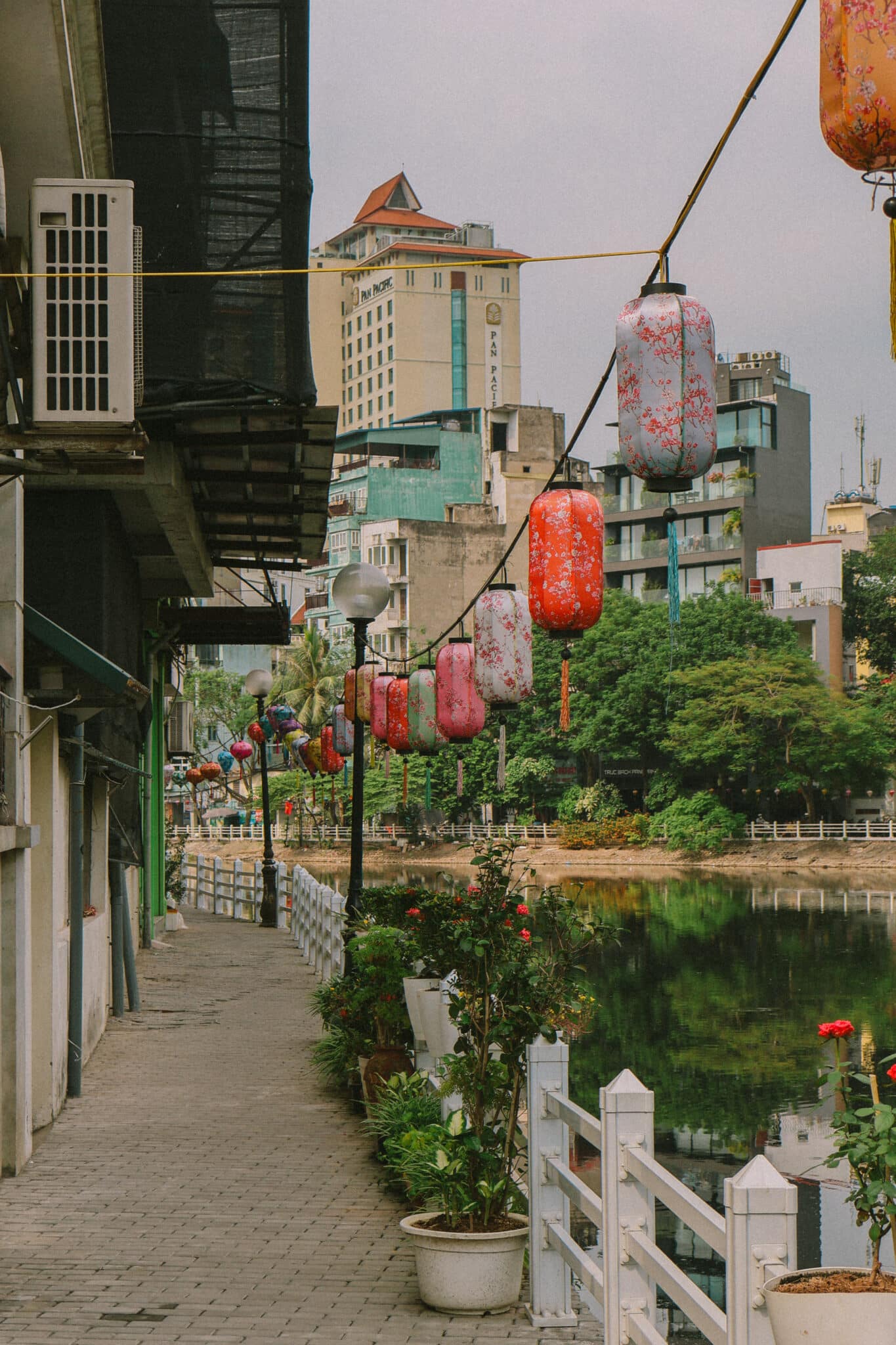 Hanoi hidden gem: Lanterns line a peaceful lakeside walkway in Hanoi, Vietnam.
