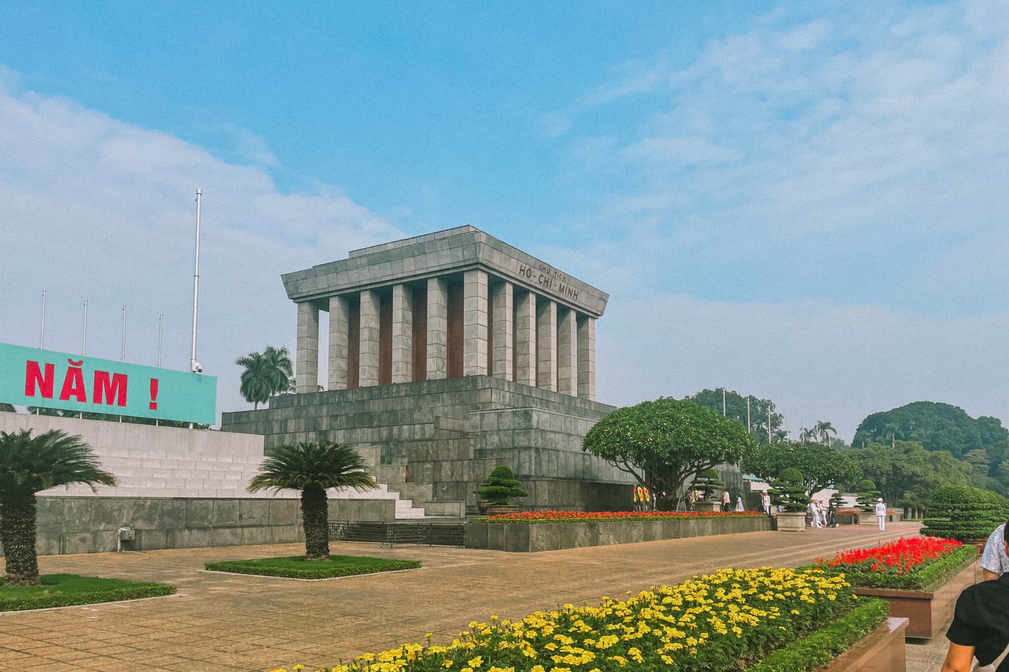 Ho Chi Minh Mausoleum in Hanoi, Vietnam, surrounded by flowers. Exploring things to do in Hanoi.