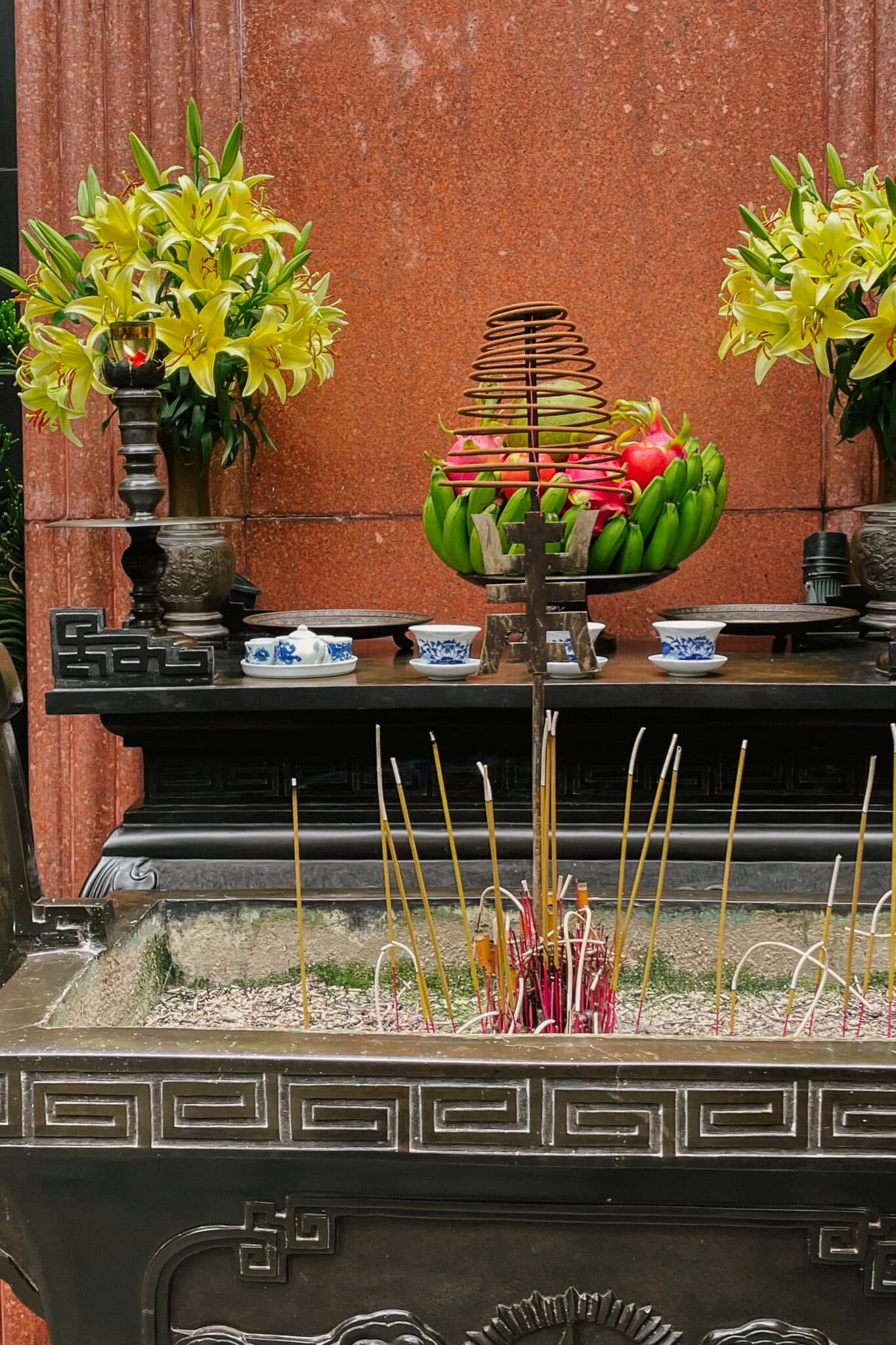 Hanoi museum altar with flowers, fruit, incense. Culture and tradition in Vietnam.