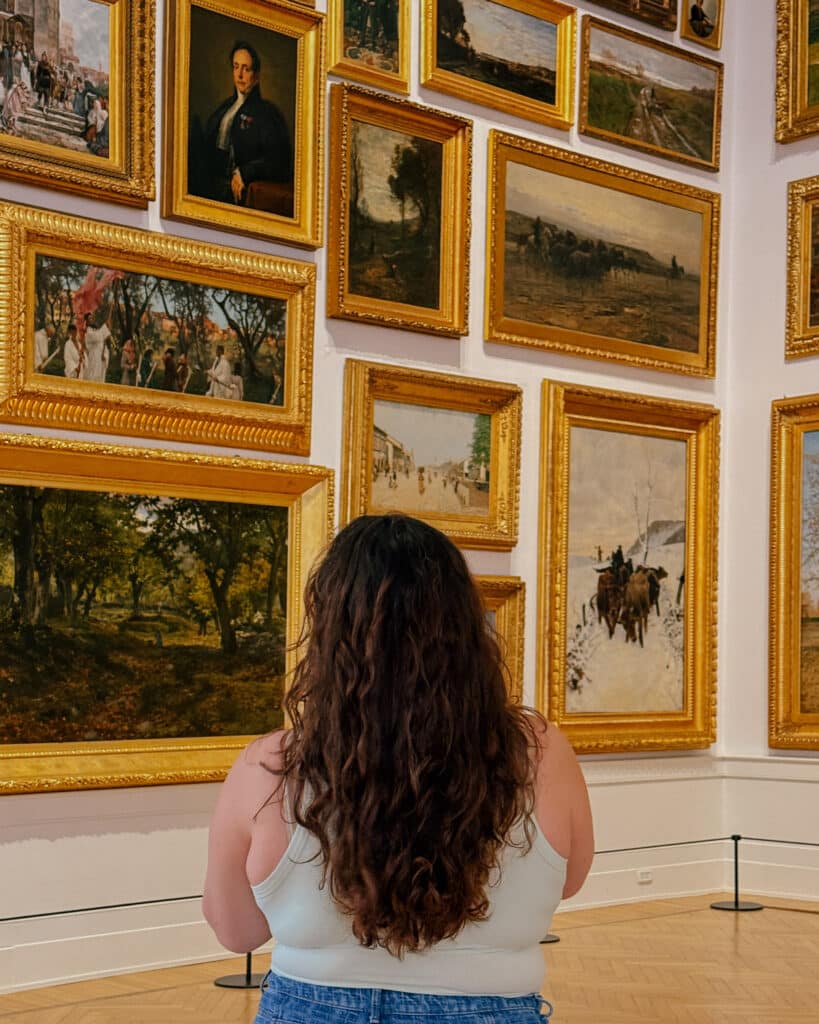 Woman views art in Rome gallery, Jet2CityBreak inspiration.