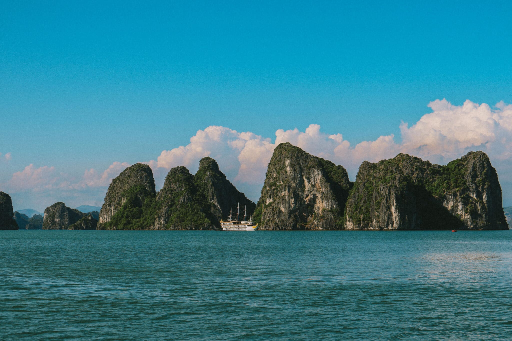 L'Amour Junk on a private Ha Long Bay cruise amidst limestone karsts.