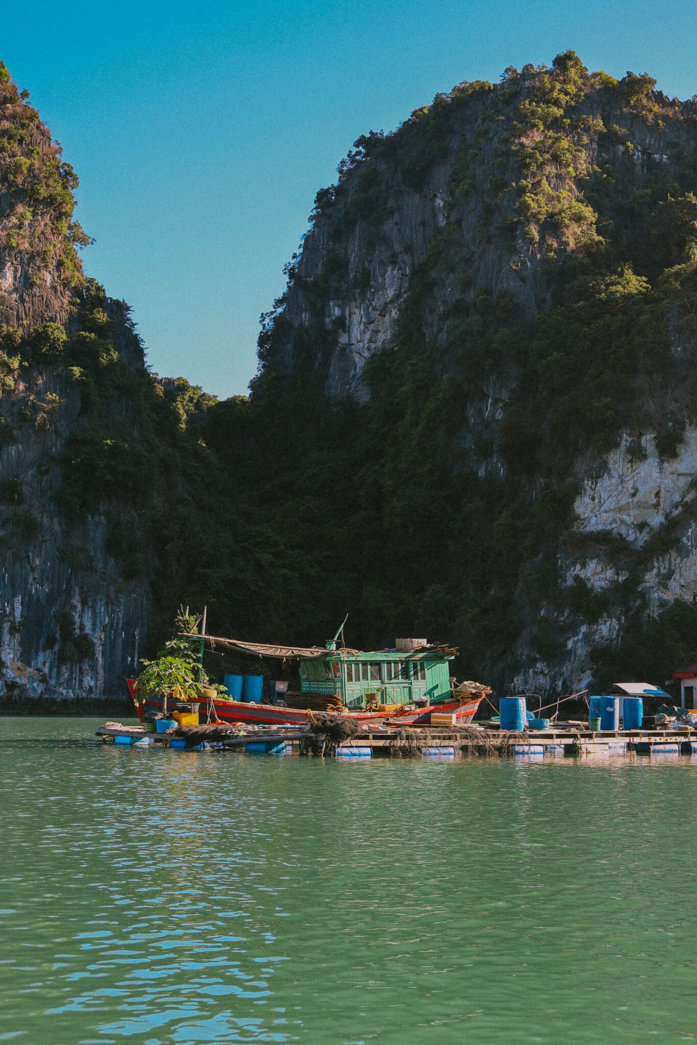 L'Amour Junk boat on a private Ha Long Bay cruise amidst limestone karsts.