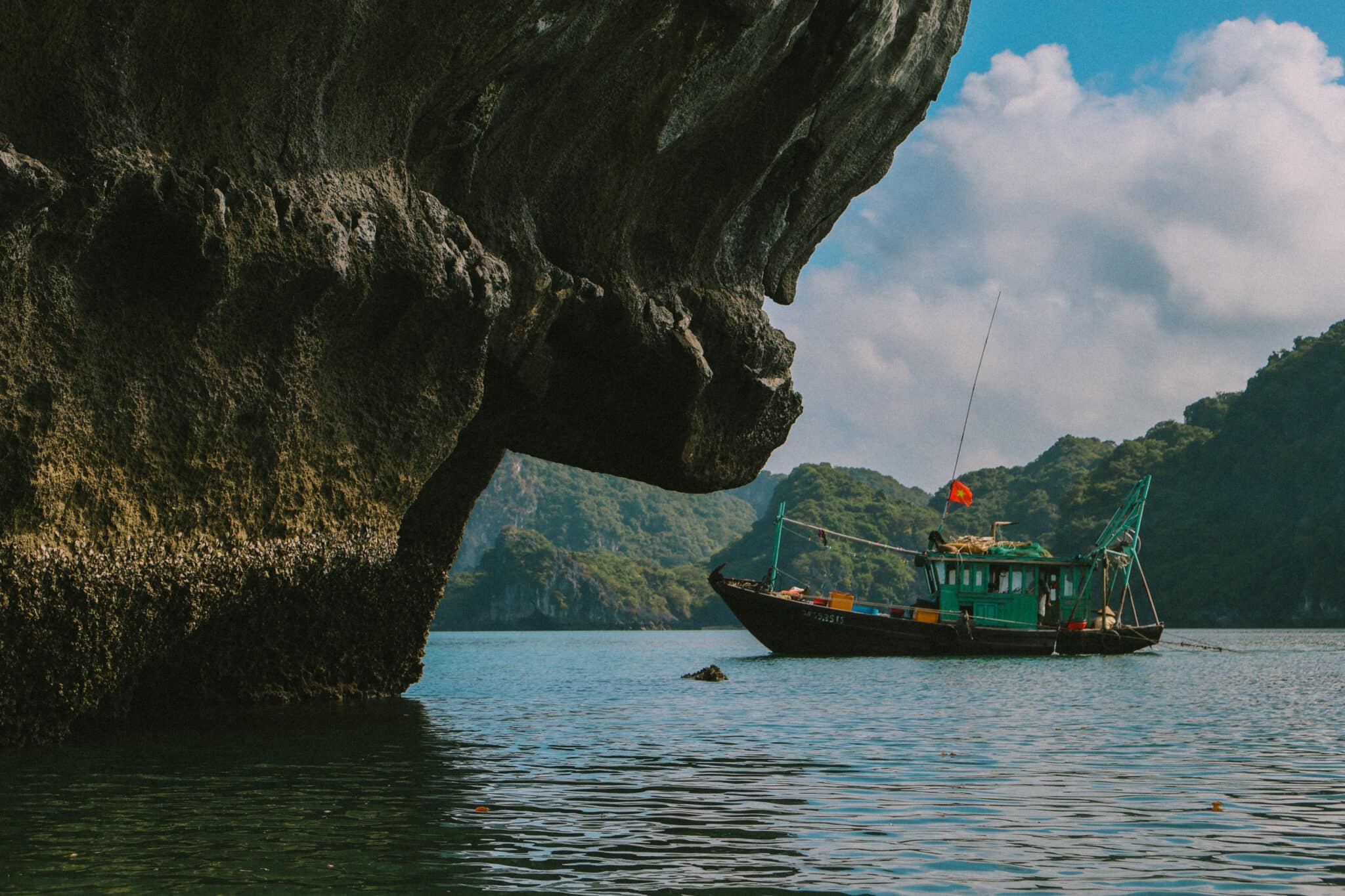 L'Amour Junk on a private Ha Long Bay cruise, amidst towering limestone karsts.