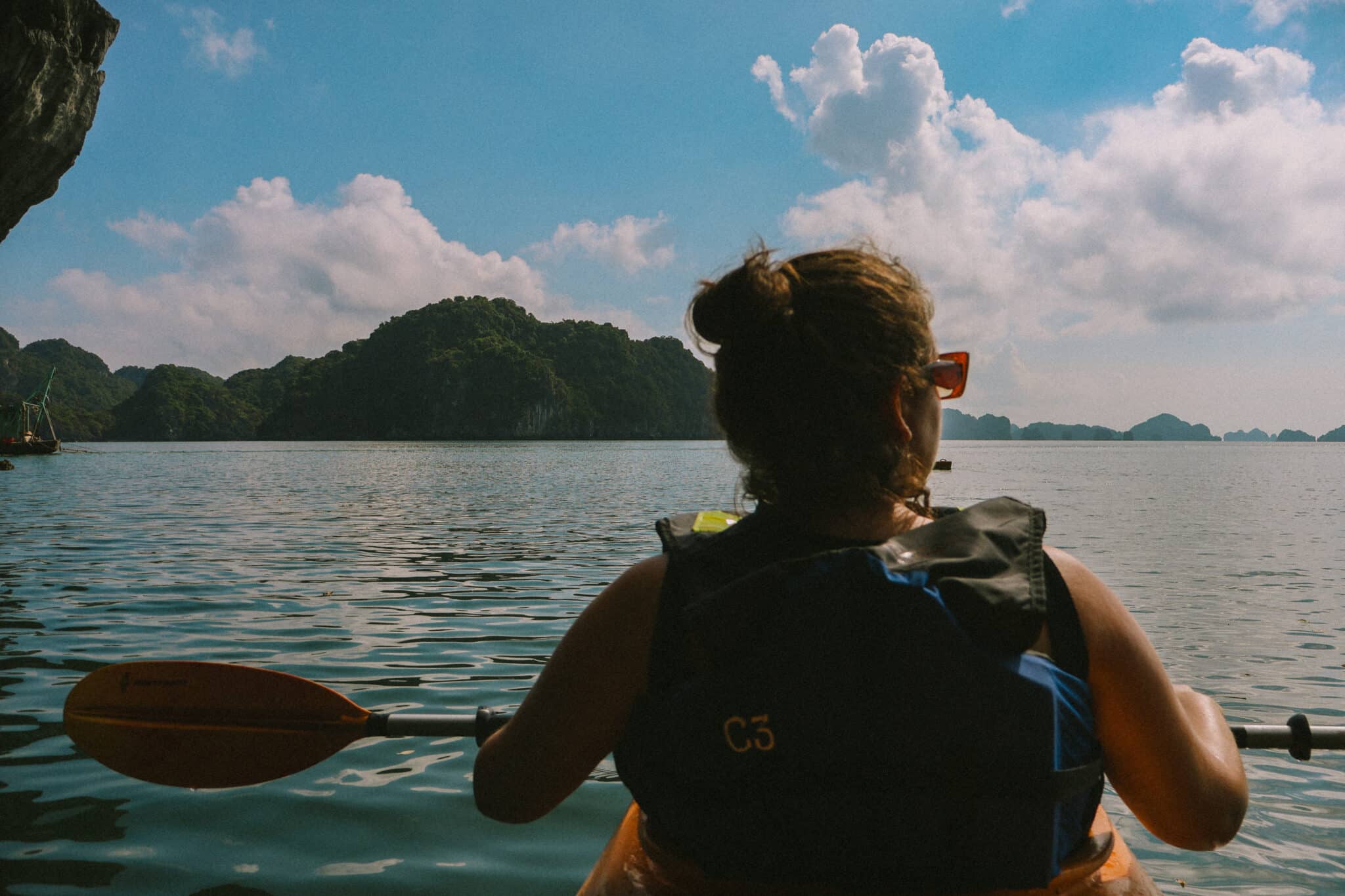 Woman kayaking on a private Ha Long Bay cruise on L'Amour Junk