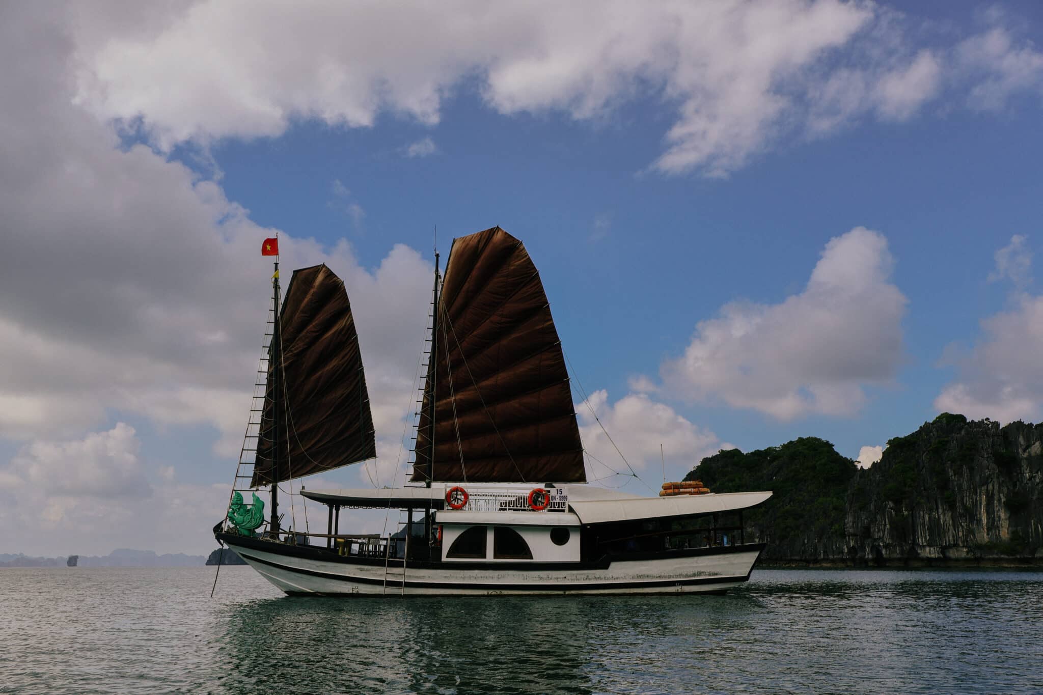 L'Amour Junk, a luxury Ha Long Bay cruise boat with brown sails, on a private Ha Long Bay cruise.