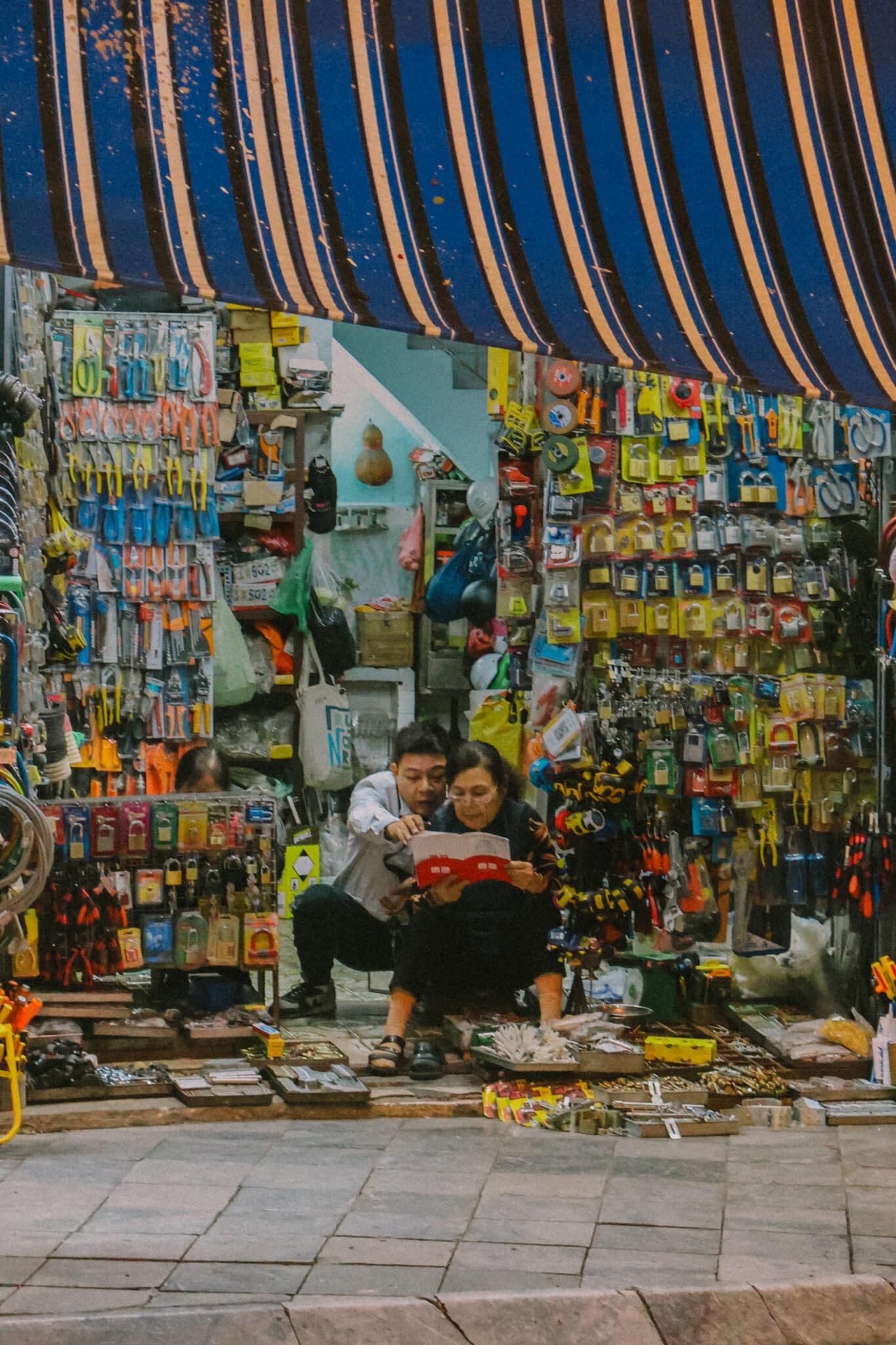 Couple browsing hardware in Hanoi Old Quarter shop
