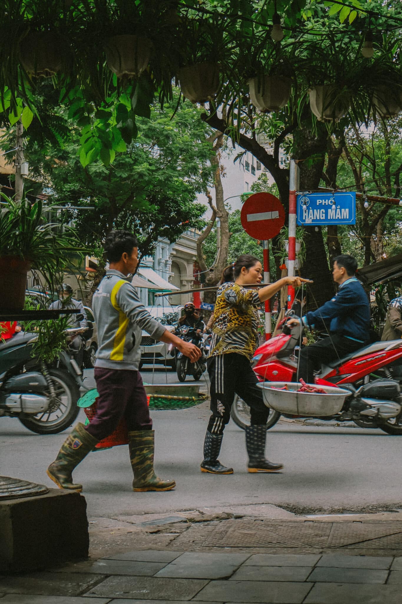 Hanoi Old Quarter street scene with people and motorbikes