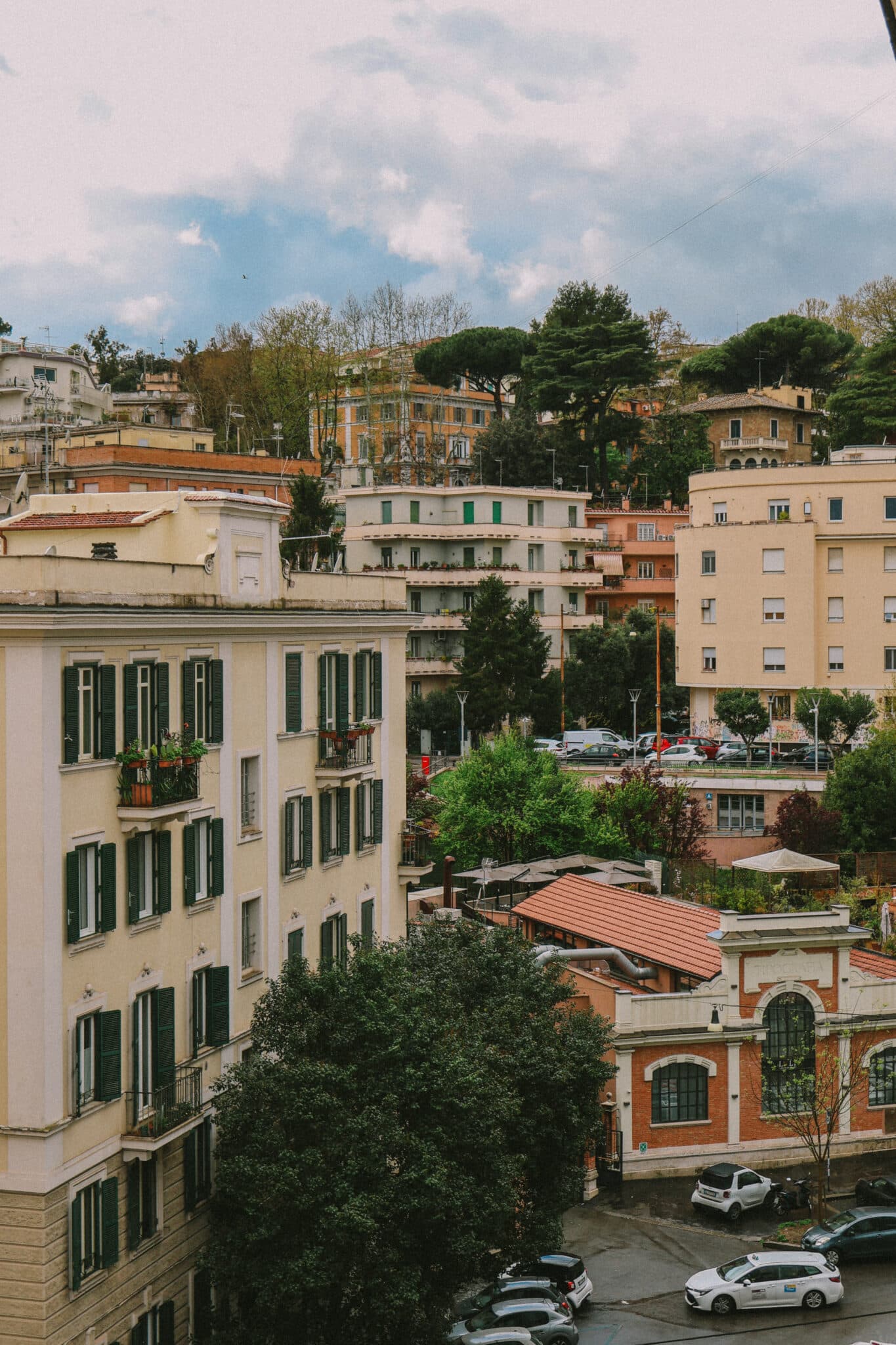 Rome cityscape featuring apartment buildings with green shutters and rooftop terraces, perfect for a Jet2CityBreak to Rome.