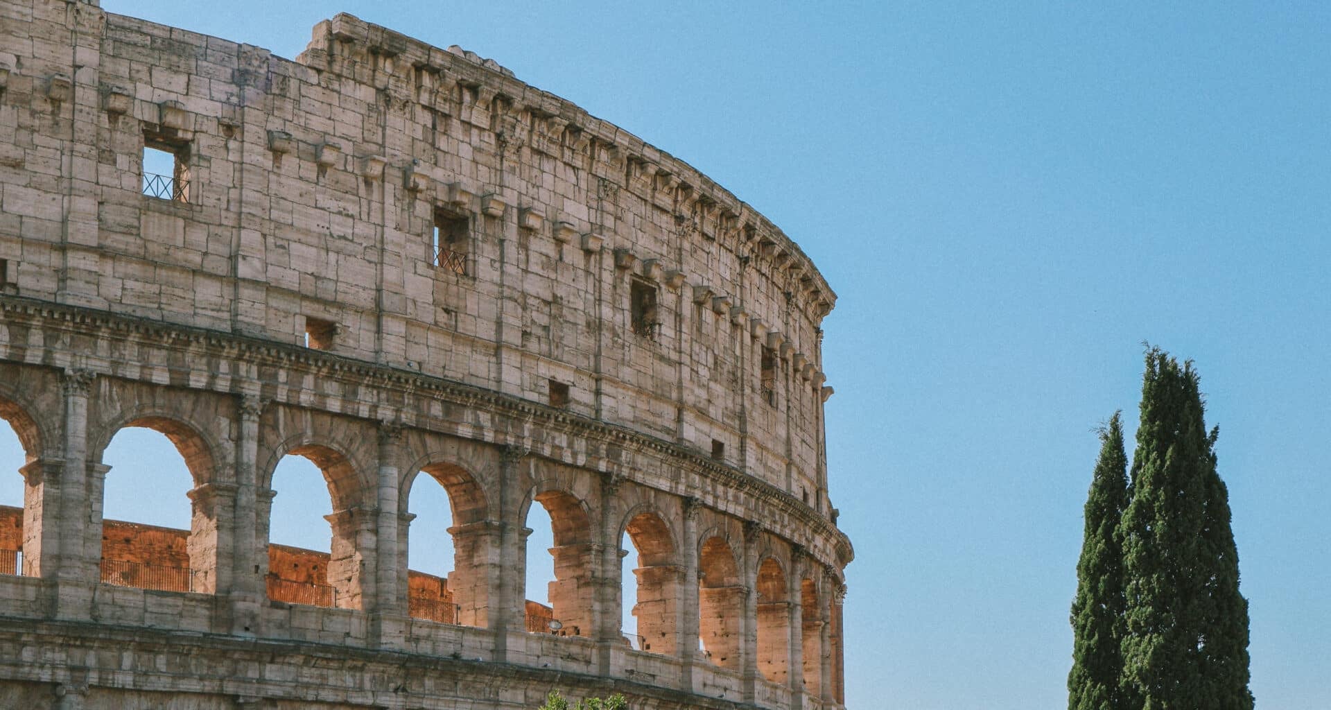 Rome Colosseum view with trees, perfect for a Jet2CityBreak to Rome.