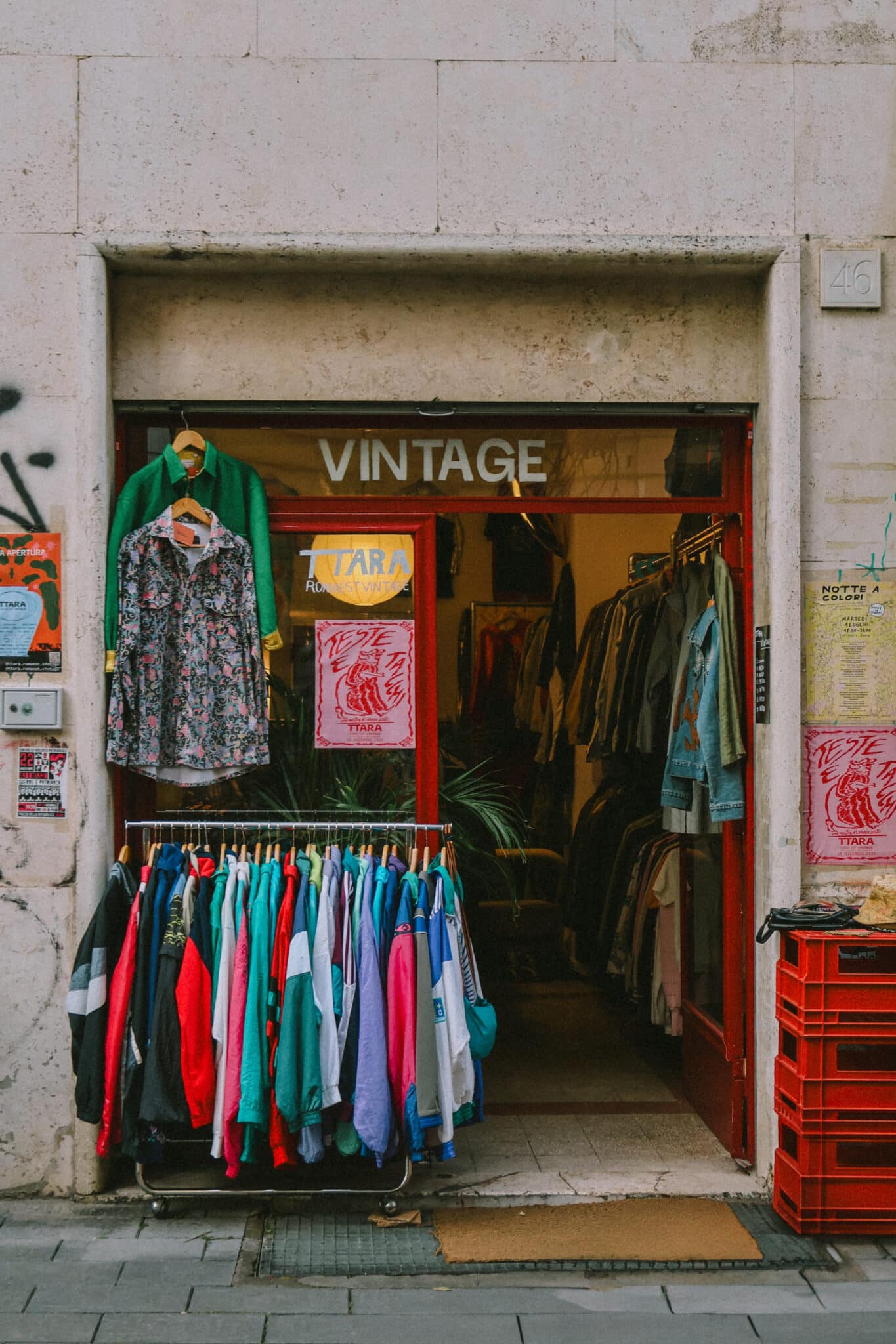 Vintage clothing store in Rome, Italy, featuring colorful garments. "Vintage" sign visible. Jet2CityBreak travel inspiration.