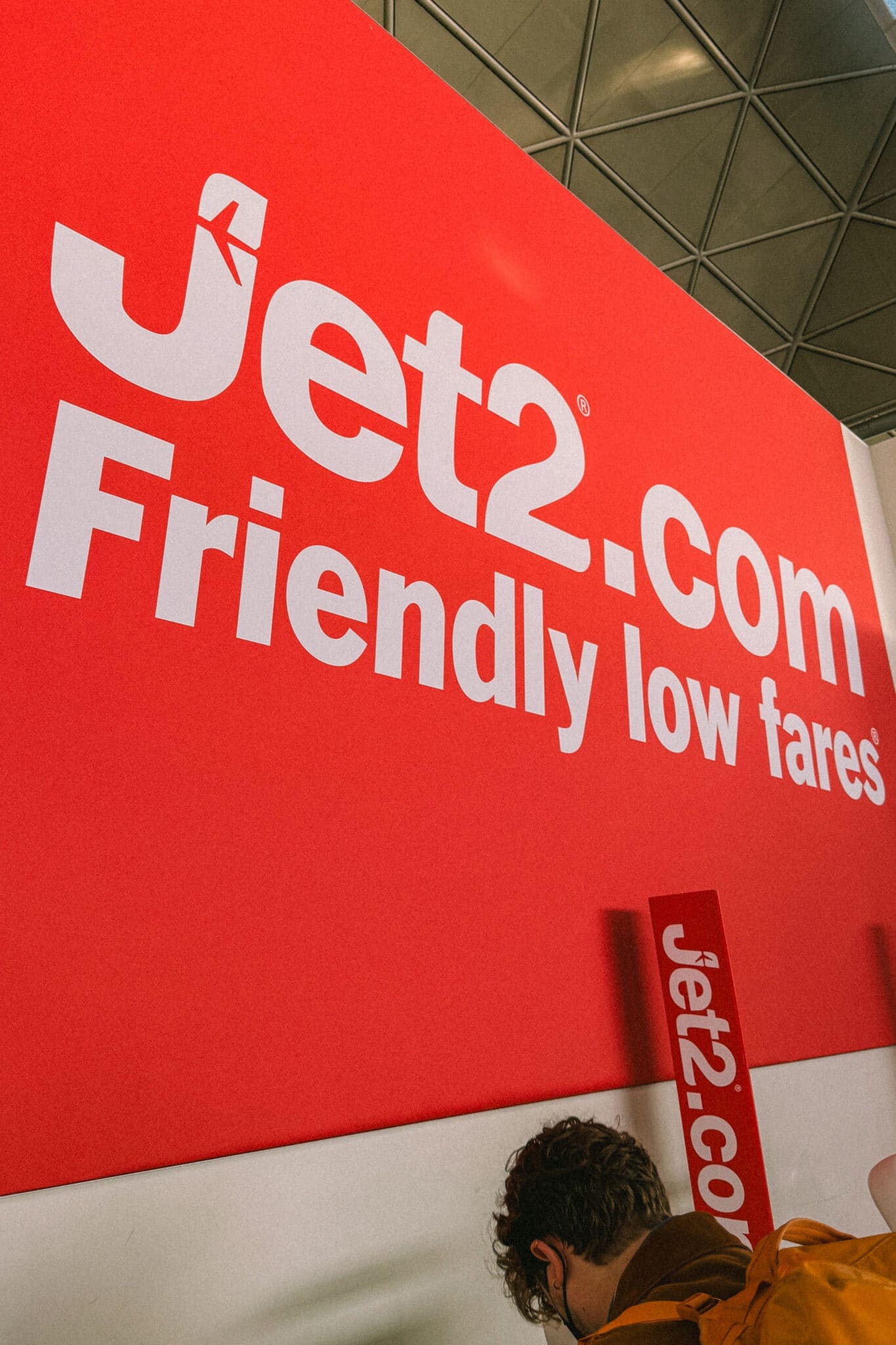 Daniel completes check-in at Jet2.com desk at Stansted airport.