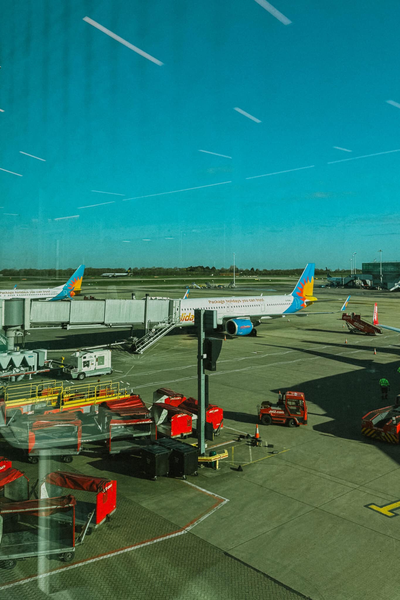 Jet2CityBreak plane at an airport gate in Rome, with ground crew and equipment.