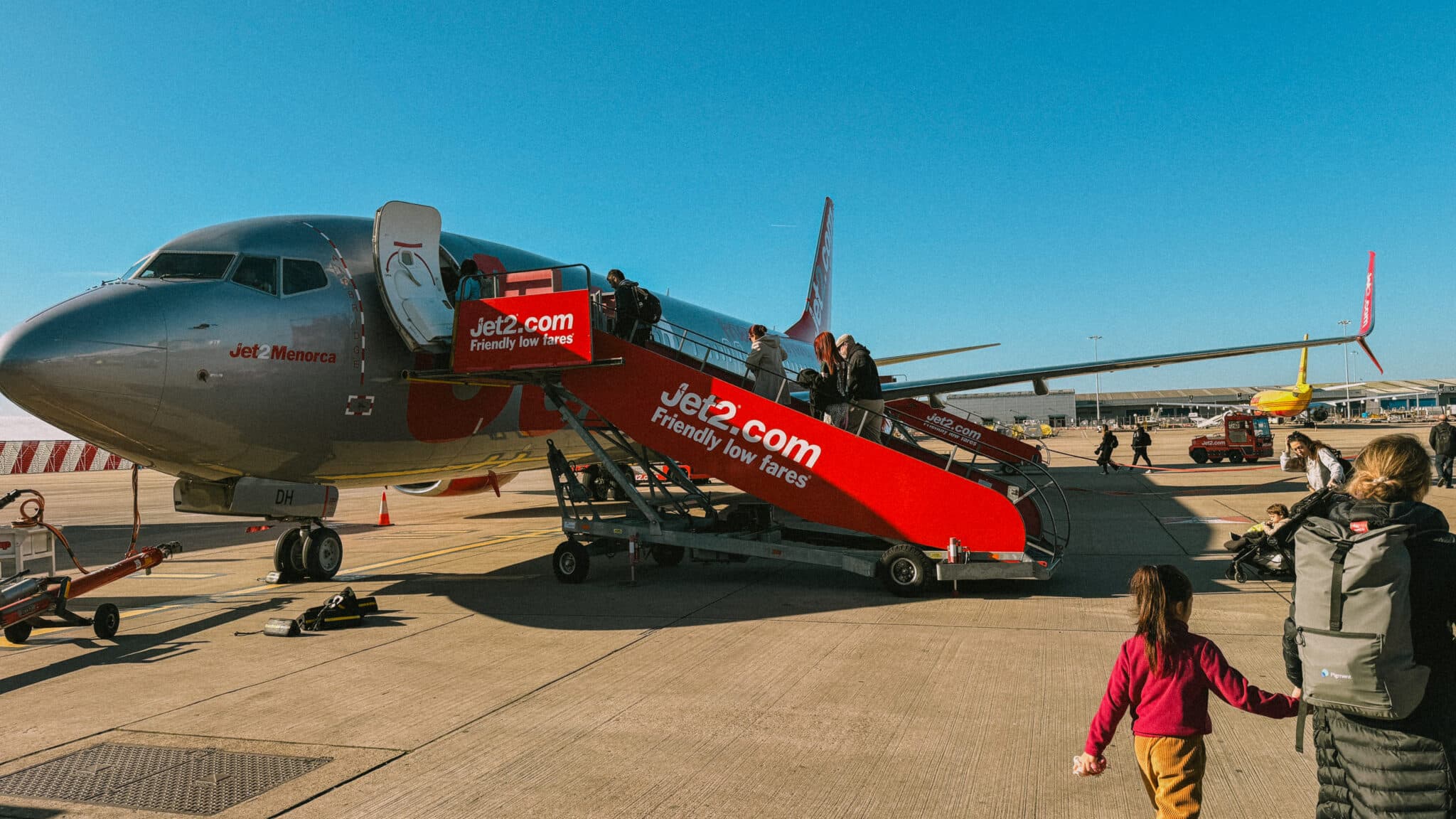 Jet2 plane boarding passengers, "Jet2.com Friendly low fares" on stairs. Jet2CityBreak to Rome travel.
