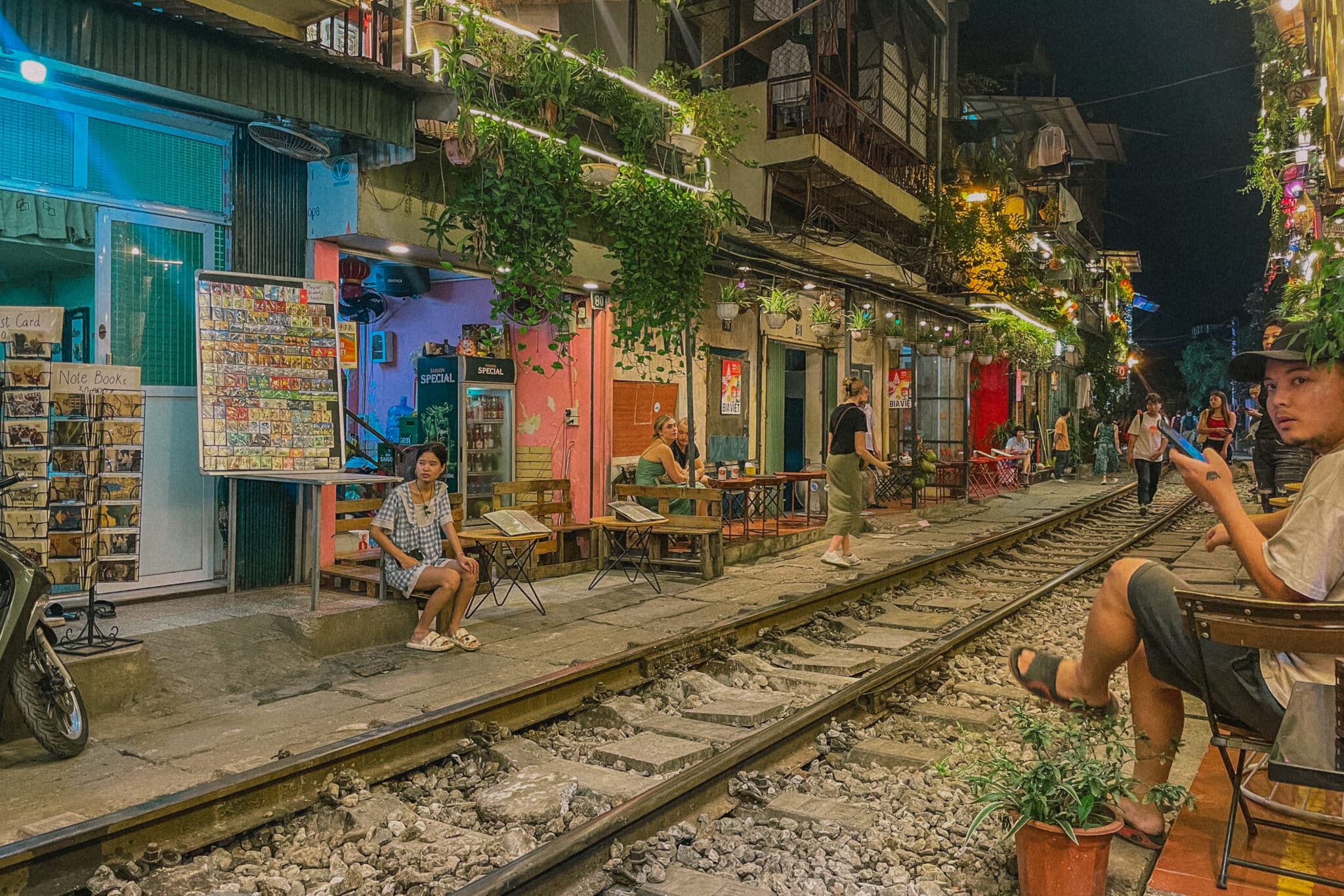 Hanoi Old Quarter train street at night with cafes and people