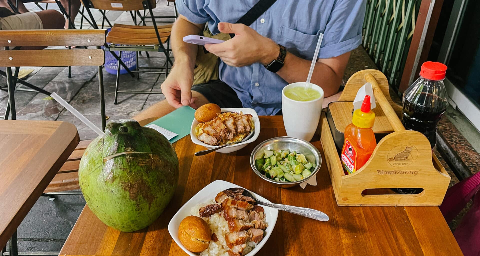 Hanoi street food: grilled pork and rice with coconut and condiments
