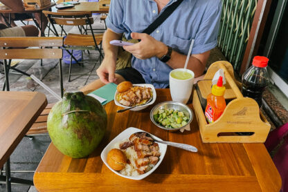 Hanoi street food: grilled pork and rice with coconut and condiments