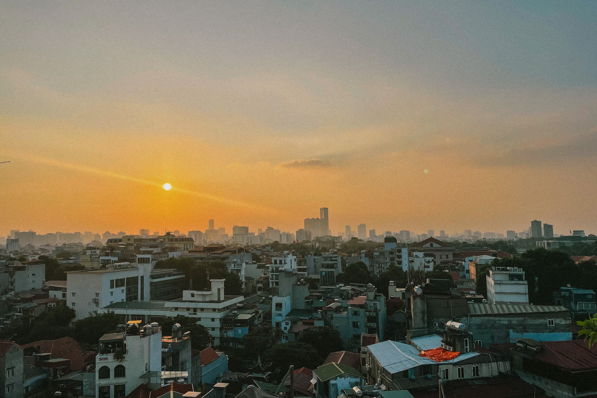 Hanoi cityscape at sunset, hinting at vibrant dining and nightlife.