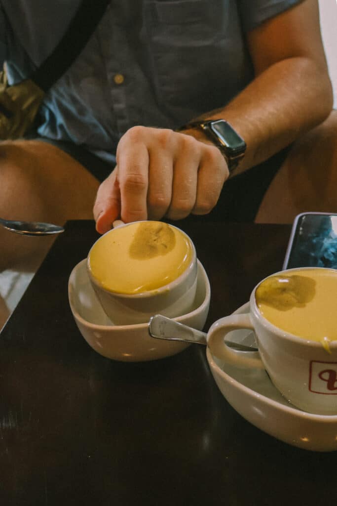 Two cups of egg coffee at a Hanoi cafe, Cafe Giang, a popular spot where to eat in Hanoi where egg coffee was invented