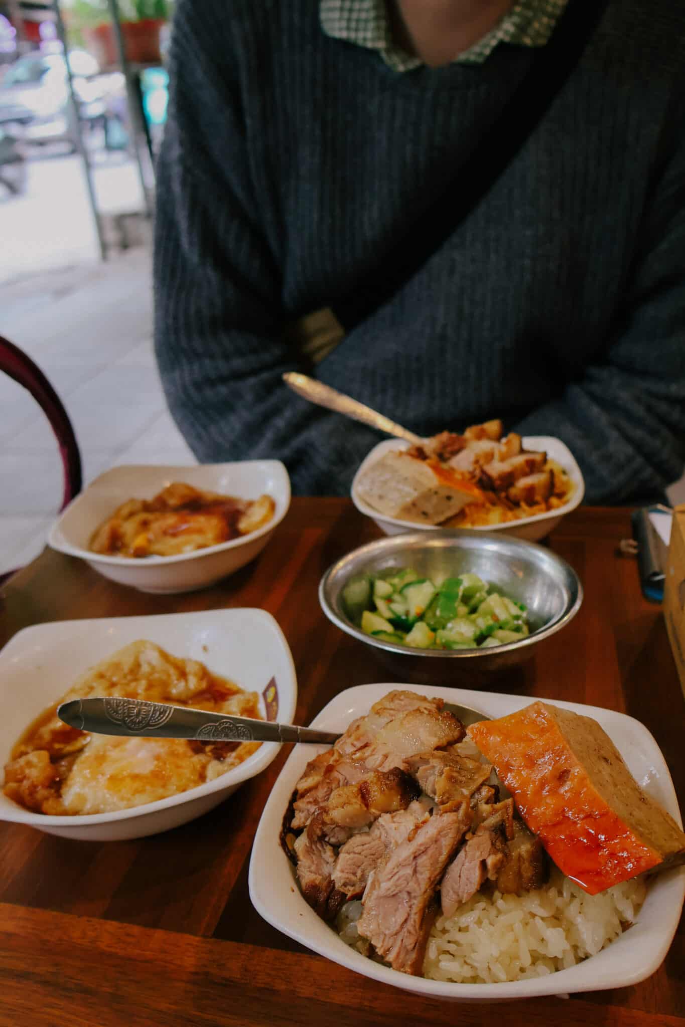 Hanoi street food: Sticky rice bowls called xoi with roasted pork and fried egg, a popular Hanoi restaurant dish.